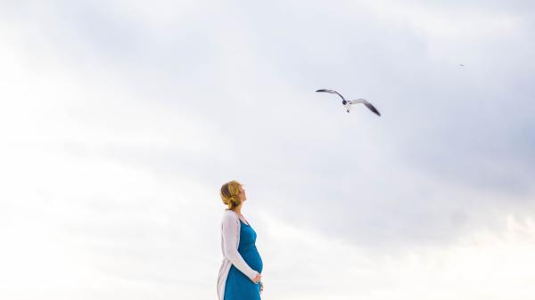 Lady with Baby bump looking at sky